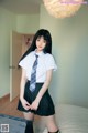 A young woman in a school uniform posing for a picture.